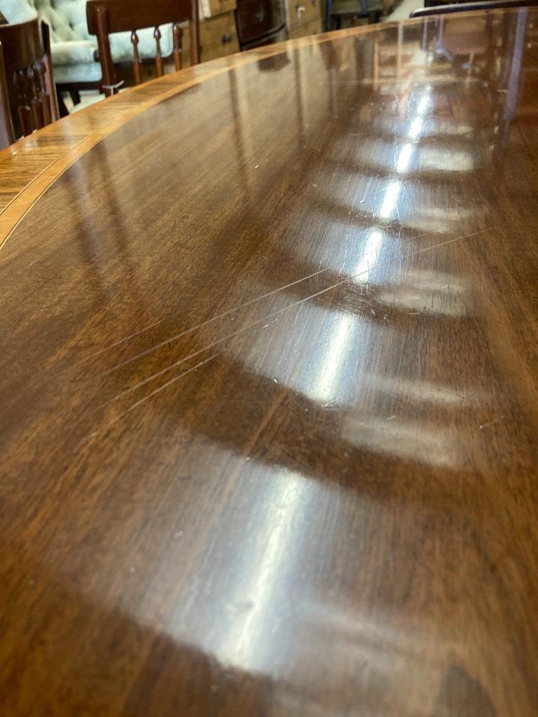 A George III style rosewood banded mahogany oval breakfast table, length 170cm, width 120cm, height 73cm